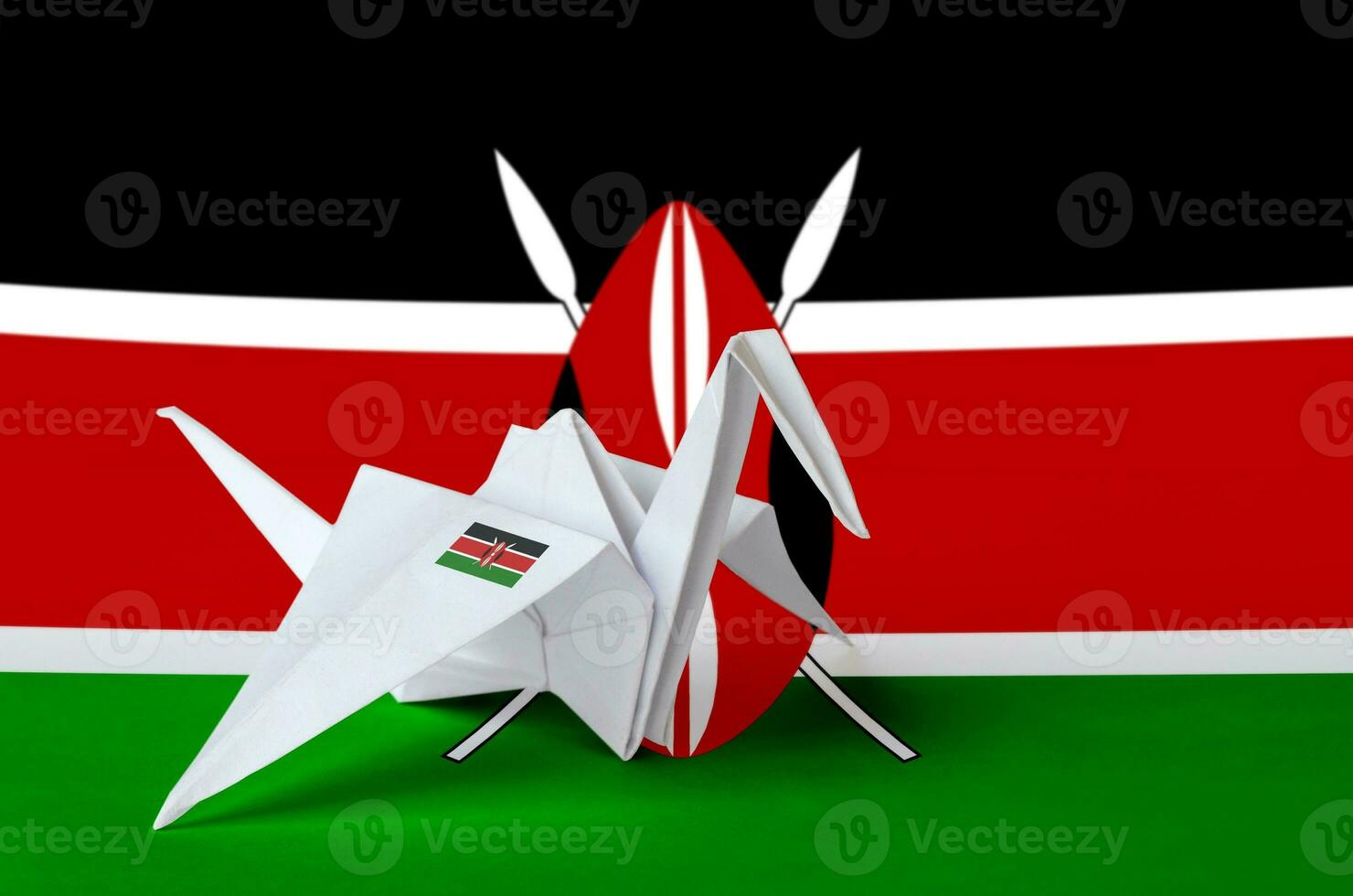 Kenya flag depicted on paper origami crane wing. Handmade arts concept photo