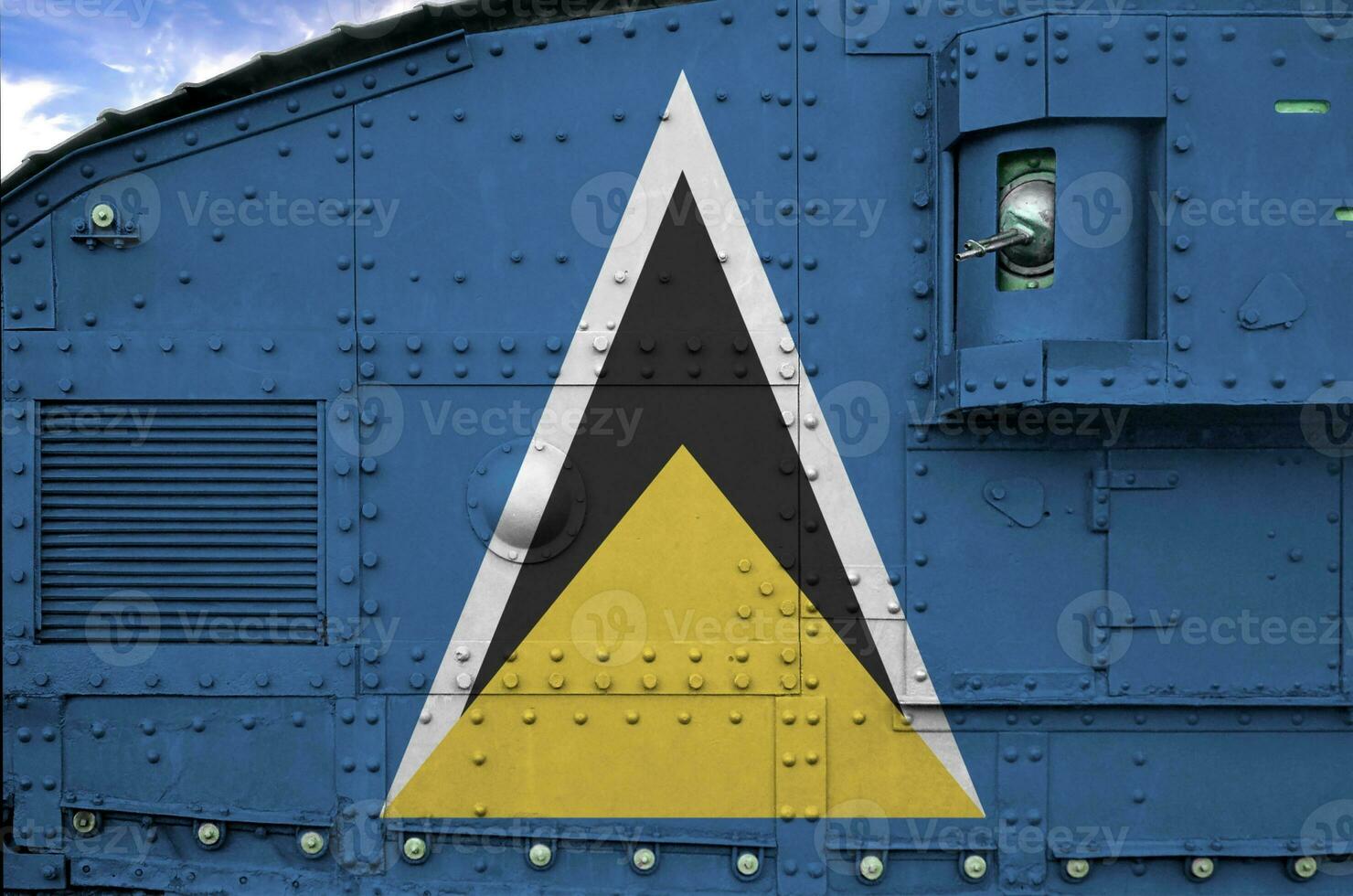 Saint Lucia flag depicted on side part of military armored tank closeup. Army forces conceptual background photo