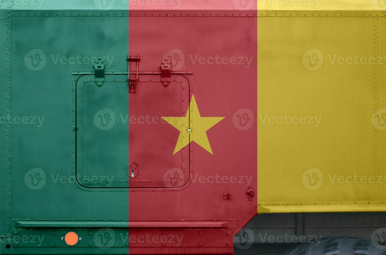 Cameroon flag depicted on side part of military armored truck closeup. Army forces conceptual background photo