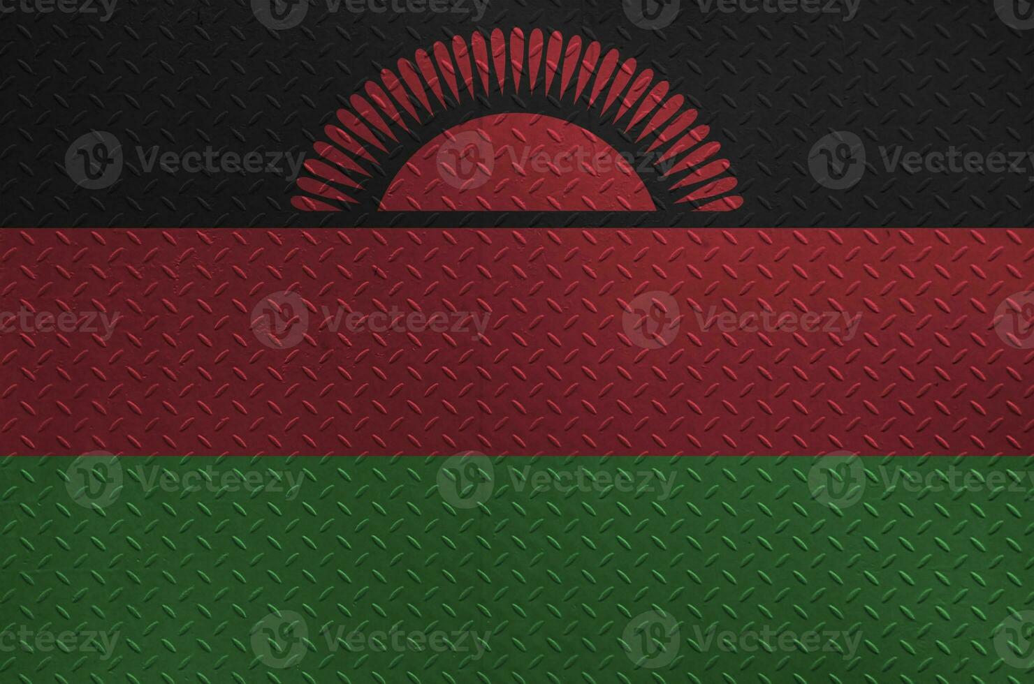 Malawi flag depicted in paint colors on old brushed metal plate or wall closeup. Textured banner on rough background photo