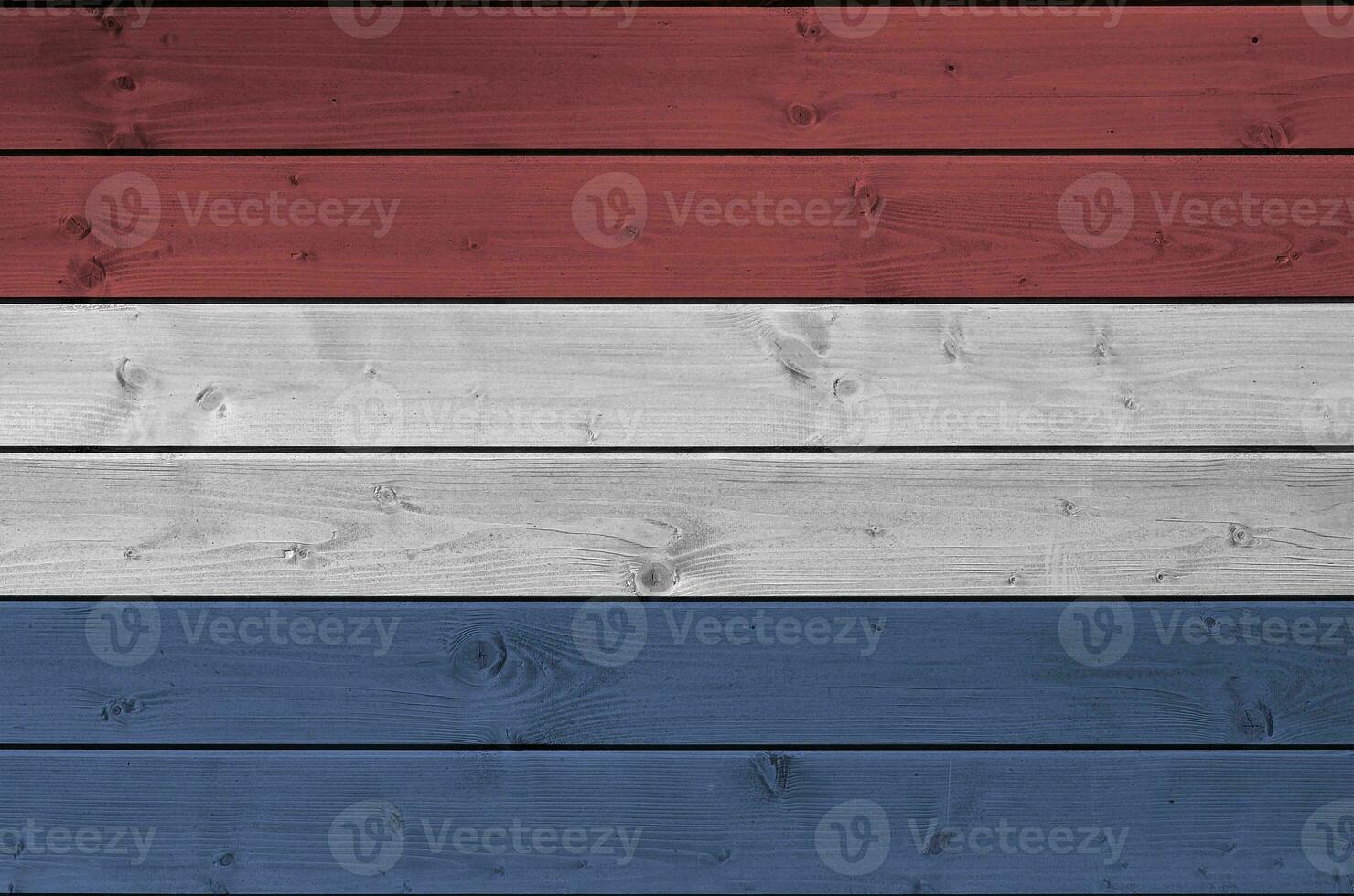 Netherlands flag depicted in bright paint colors on old wooden wall. Textured banner on rough background photo