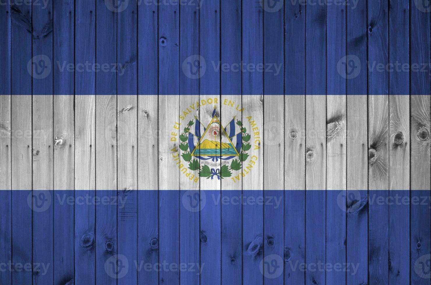 El Salvador flag depicted in bright paint colors on old wooden wall. Textured banner on rough background photo