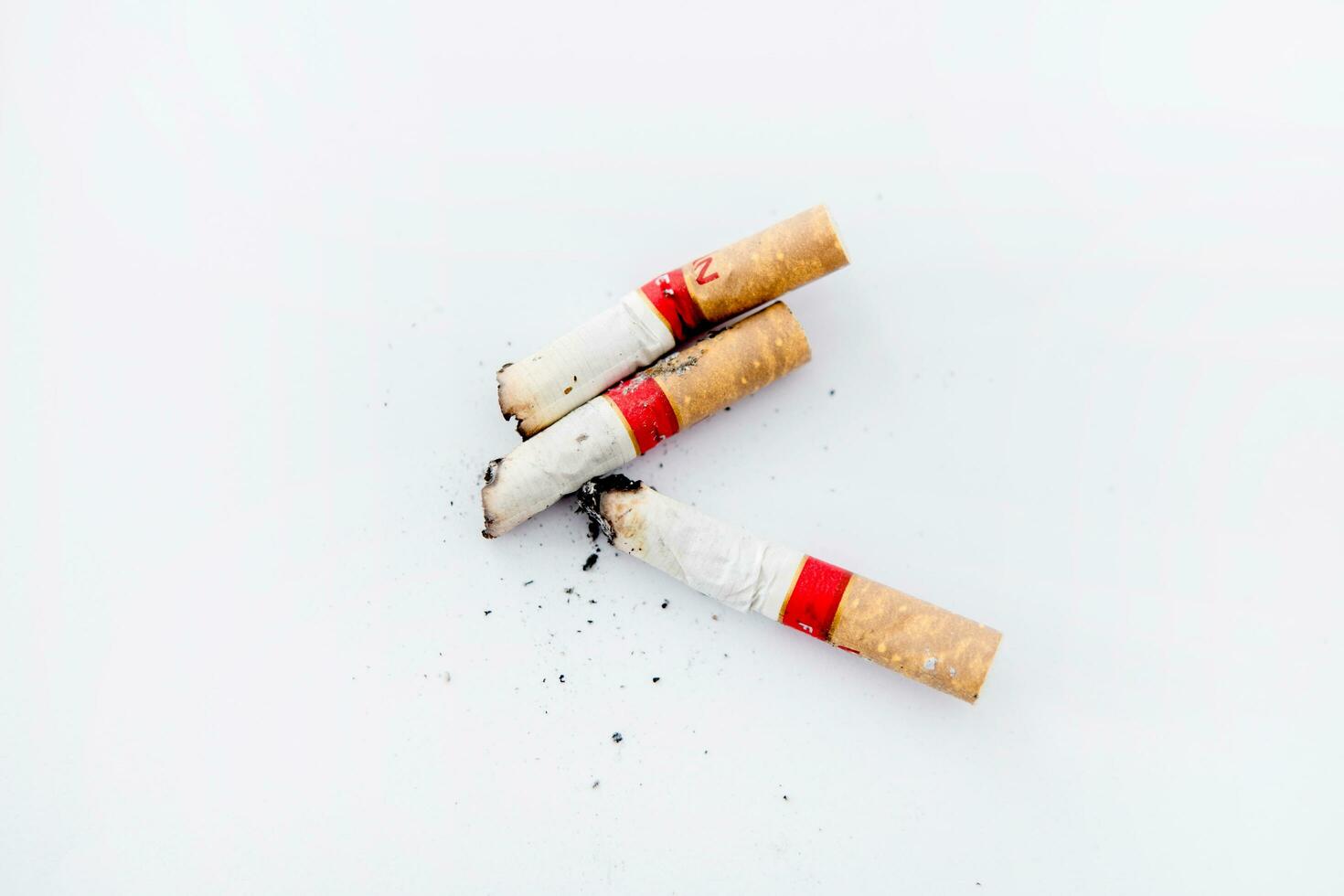 Three cigarette butts on a white background photo