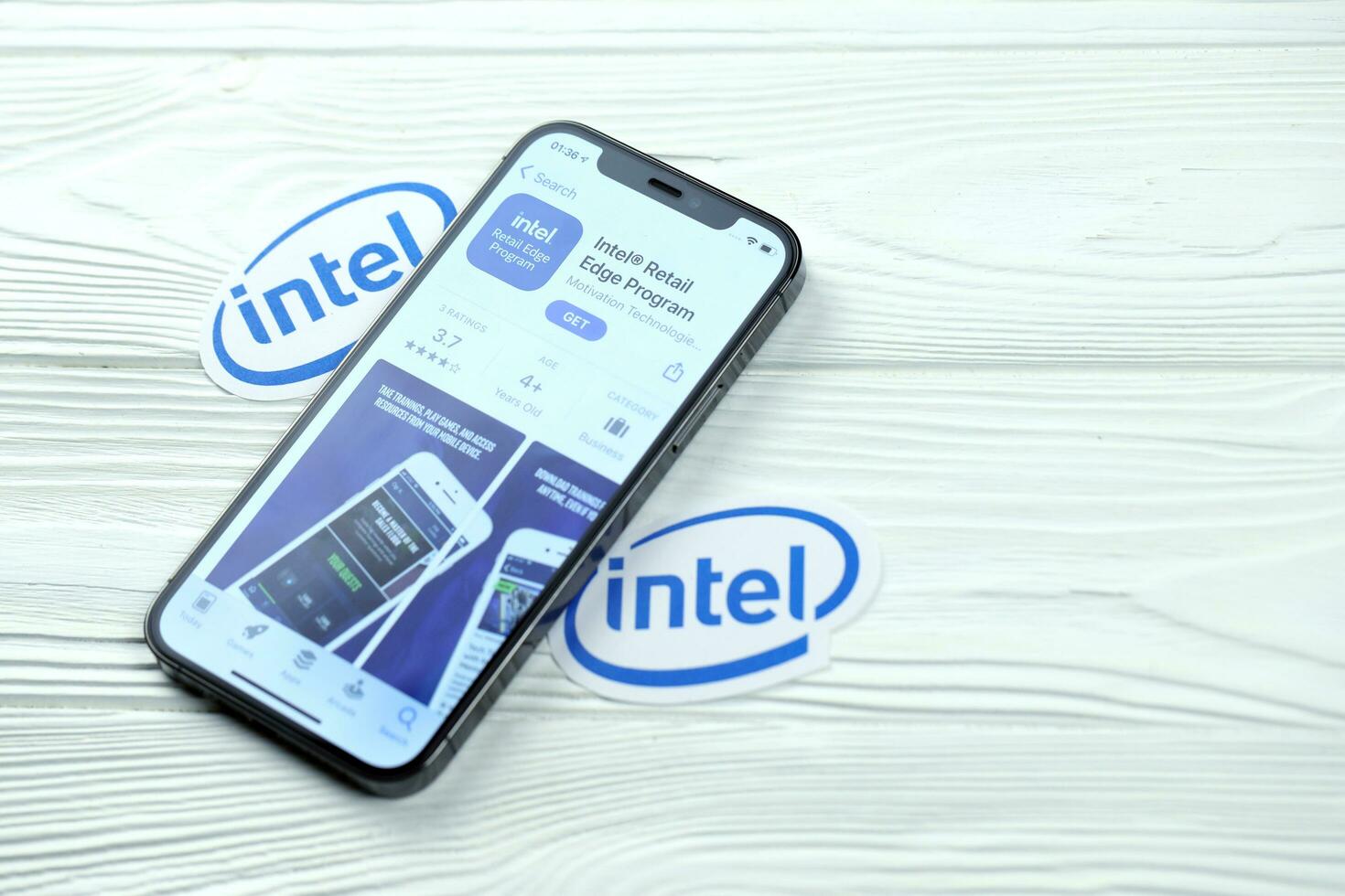KHARKOV, UKRAINE - MARCH 5, 2021 Intel icon and application from App store on iPhone 12 pro display screen on white table photo