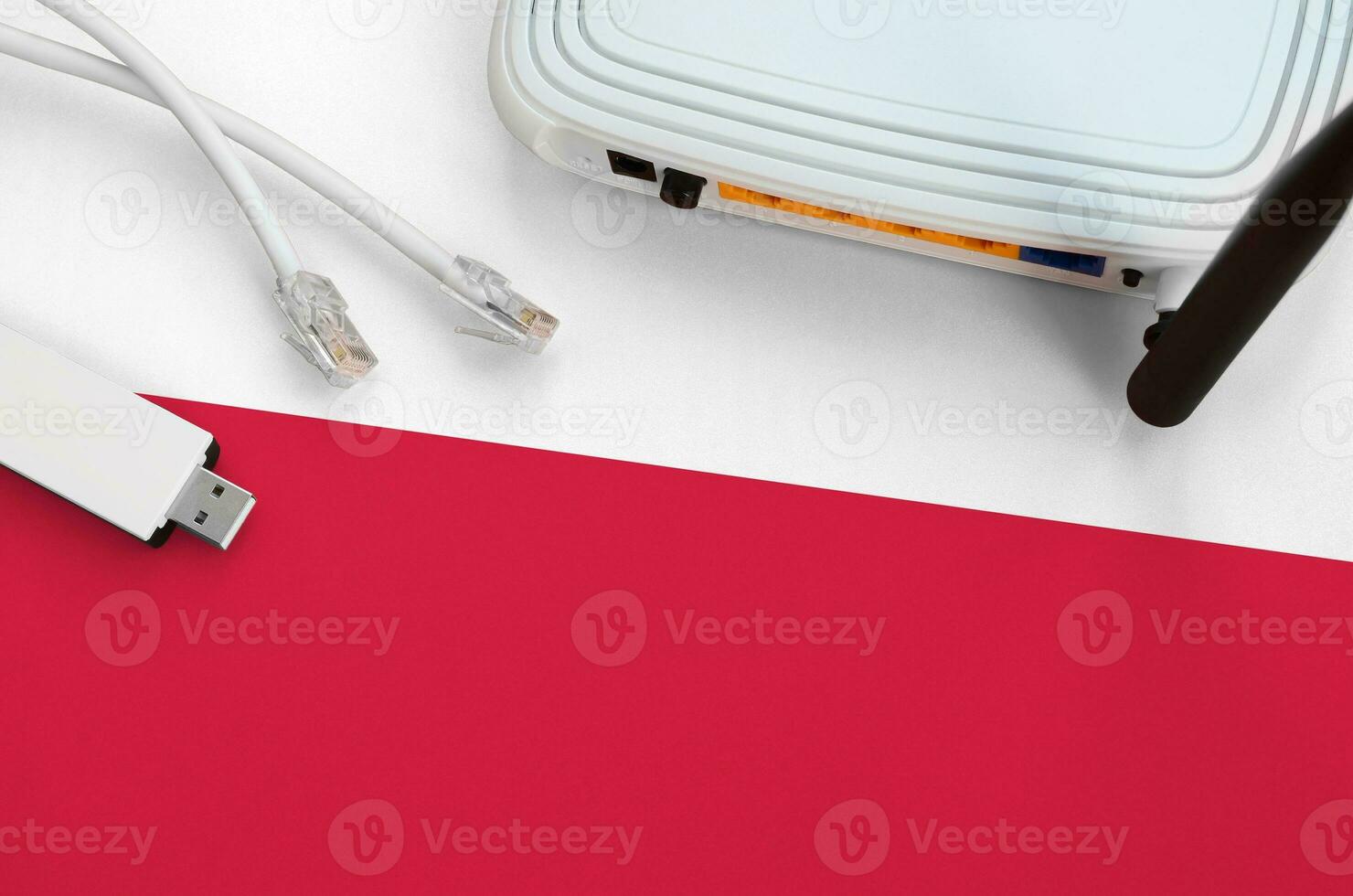 Poland flag depicted on table with internet rj45 cable, wireless usb wifi adapter and router. Internet connection concept photo