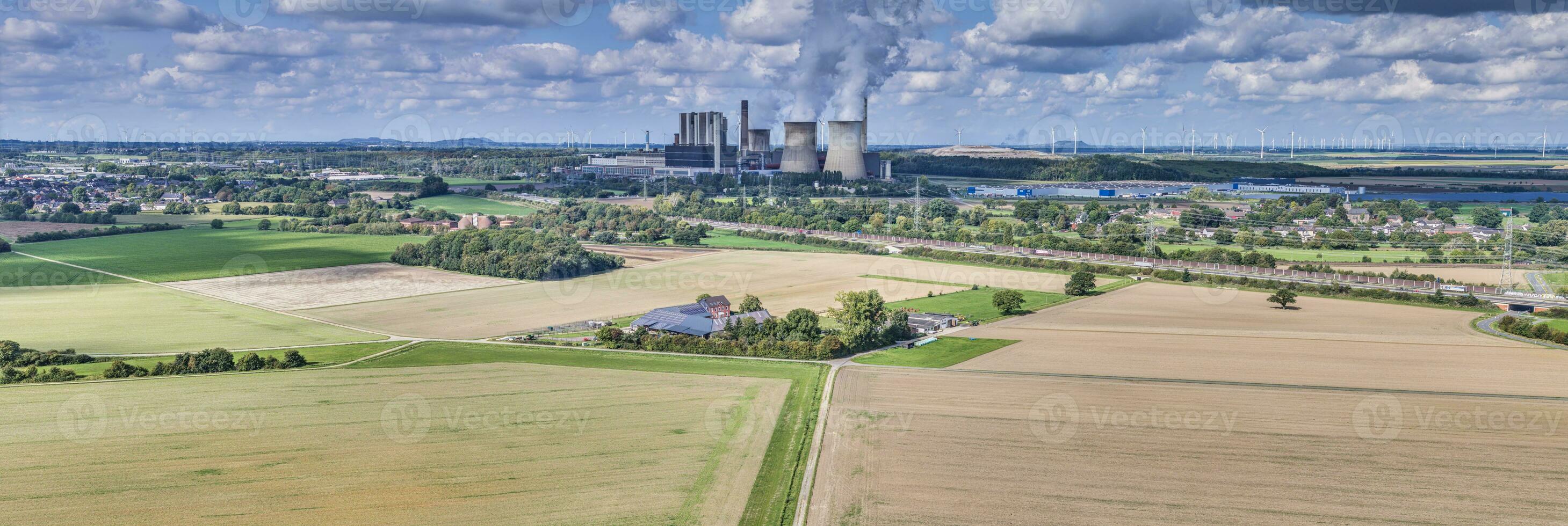 Panoramic picture of a coal-fired power station with smoking chimneys photo