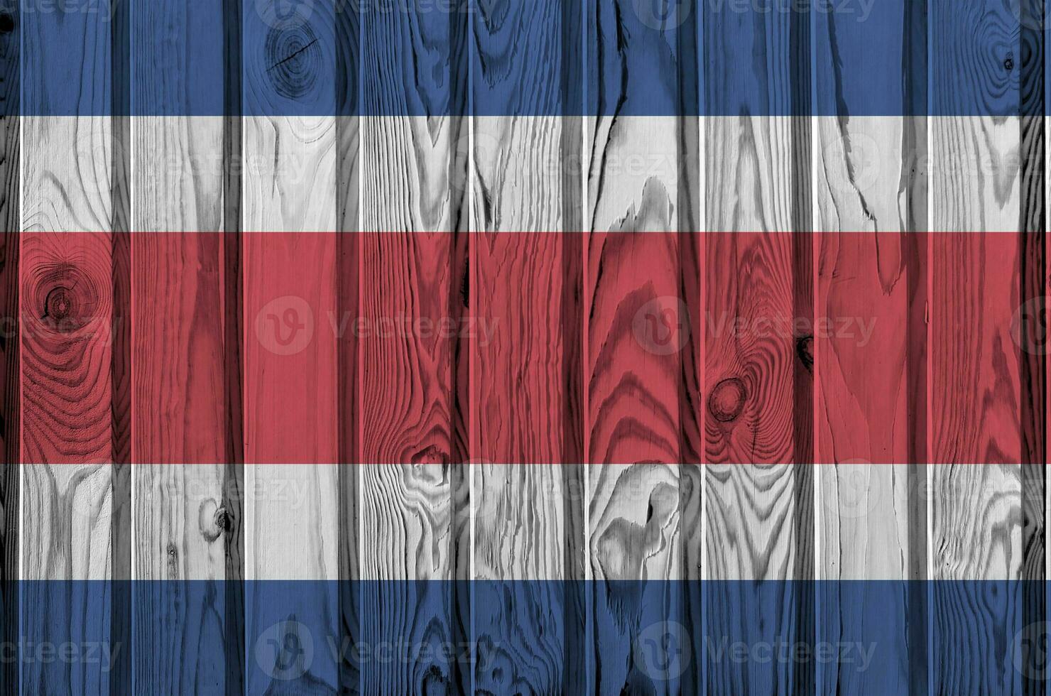 Costa Rica flag depicted in bright paint colors on old wooden wall. Textured banner on rough background photo