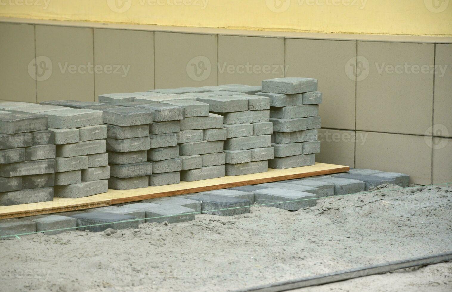 Rows of gray and dark grey walkway slab lying outdoors. Material for Paving Slabs by mosaic in progress. Cobblestone installation photo