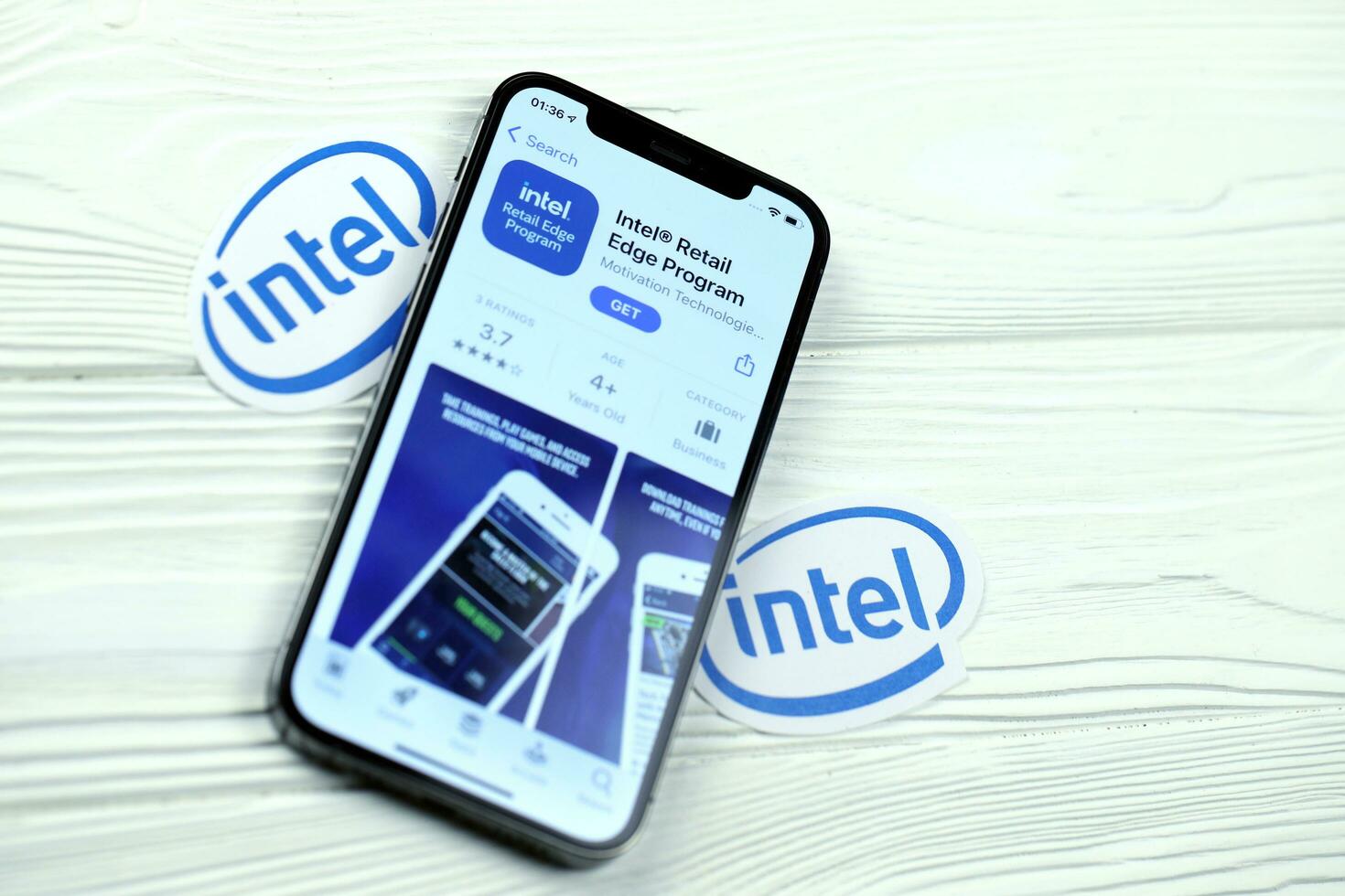 KHARKOV, UKRAINE - MARCH 5, 2021 Intel icon and application from App store on iPhone 12 pro display screen on white table photo