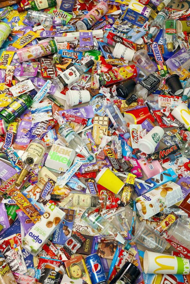 KHARKOV, UKRAINE - AUGUST 10, 2021 Big pile of various wrappings and empty disposable packages and cups from famous branded food production photo