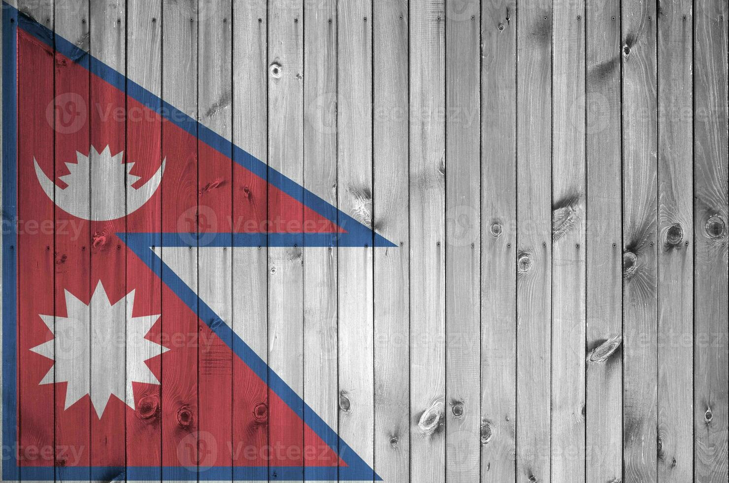 Nepal flag depicted in bright paint colors on old wooden wall. Textured banner on rough background photo