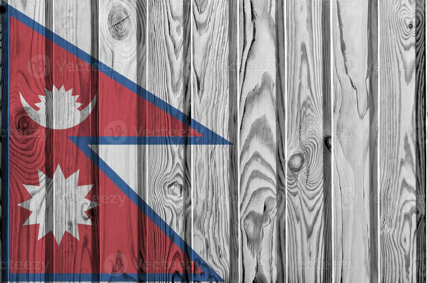 Nepal flag depicted in bright paint colors on old wooden wall. Textured banner on rough background photo