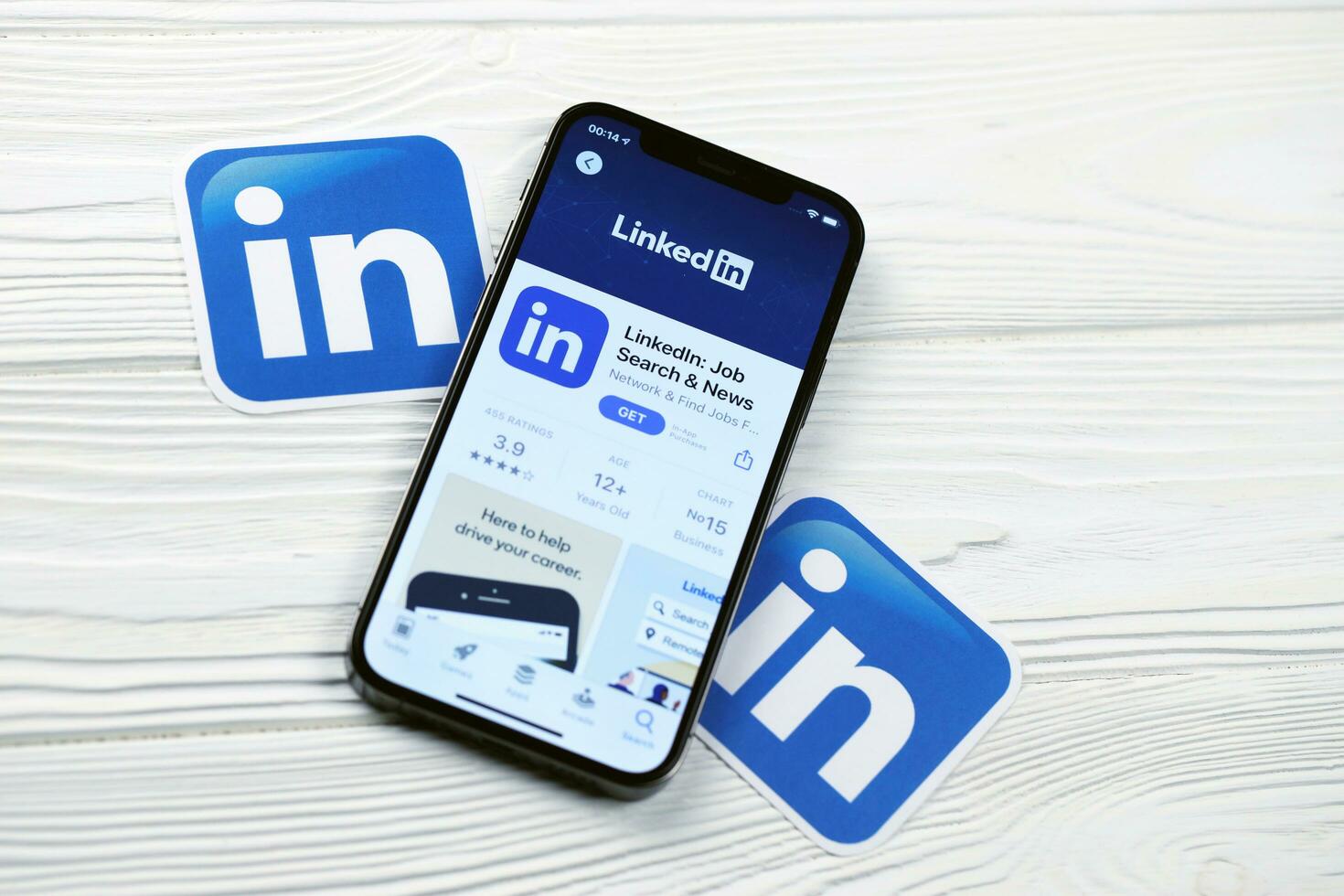 KHARKOV, UKRAINE - MARCH 5, 2021 Linkedin icon and application from App store on iPhone 12 pro display screen on white table photo