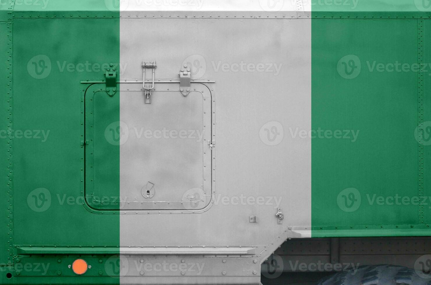 Nigeria flag depicted on side part of military armored truck closeup. Army forces conceptual background photo