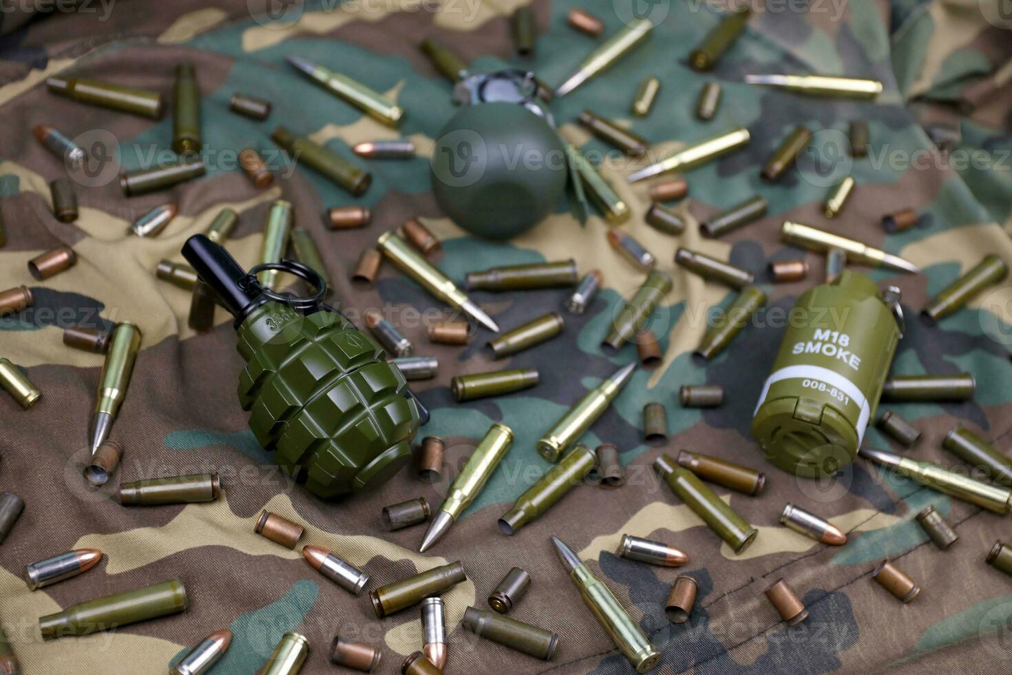 Different types of ammunition on a camouflage background. Preparing for war photo