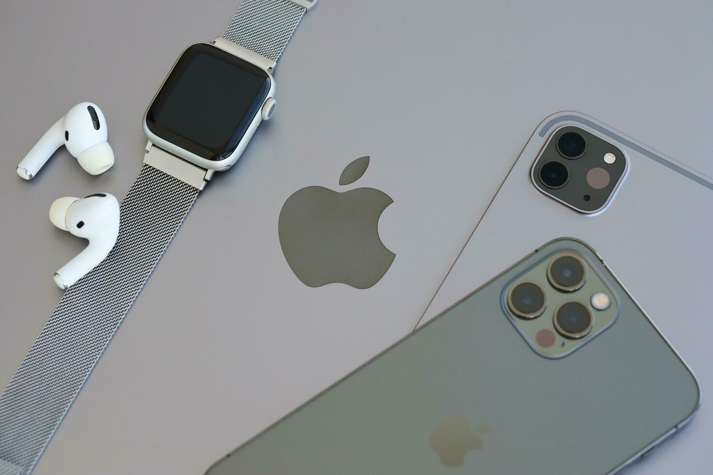 KYIV, UKRAINE - 4 MAY, 2023 Apple brand devices iphone, ipad and airpods with apple watch lies on macbook body photo
