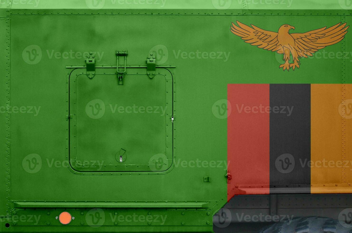 Zambia flag depicted on side part of military armored truck closeup. Army forces conceptual background photo