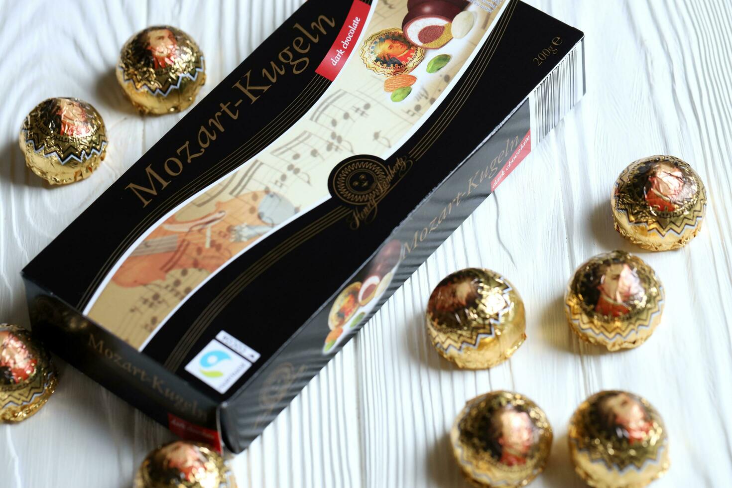 KHARKOV, UKRAINE - April 19, 2021 Henry Lambertz Mozart-Kugeln luxury dark chocolate candies in black box on white table photo