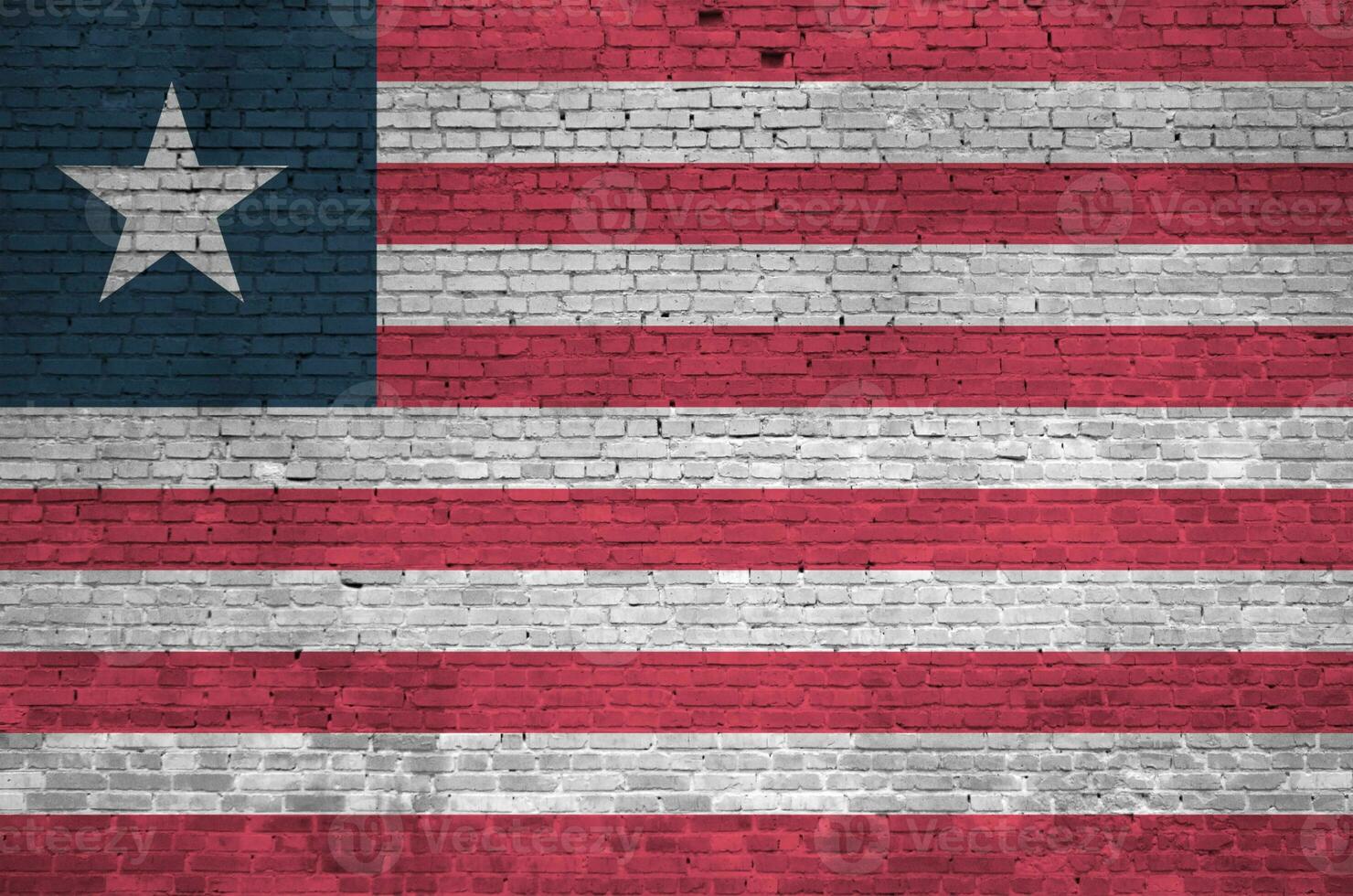 Liberia flag depicted in paint colors on old brick wall. Textured banner on big brick wall masonry background photo