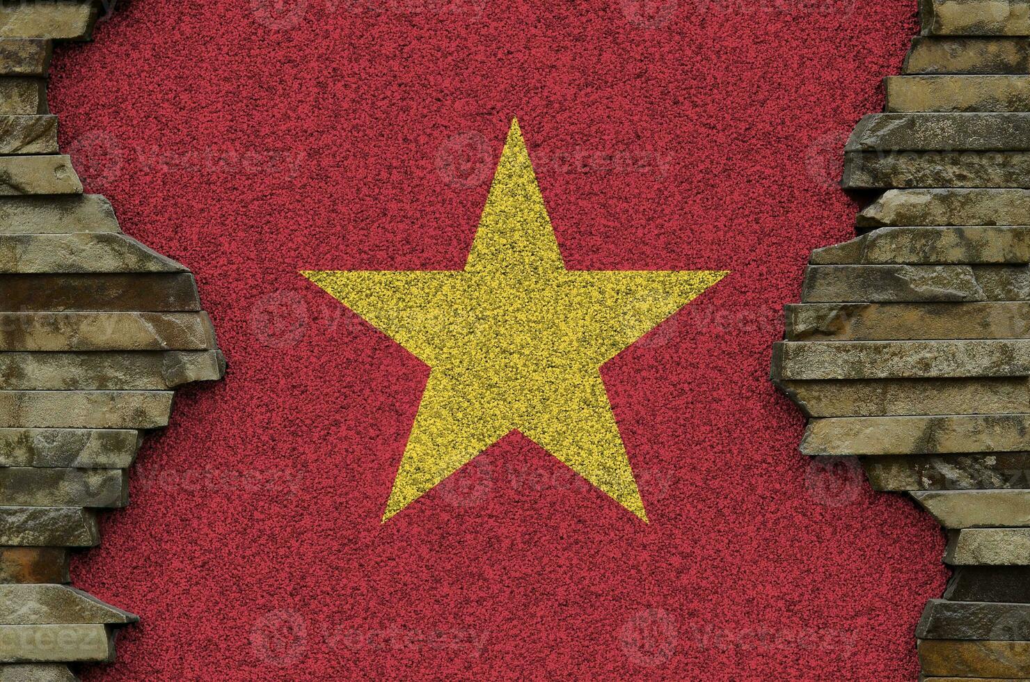 Vietnam flag depicted in paint colors on old stone wall closeup. Textured banner on rock wall background photo