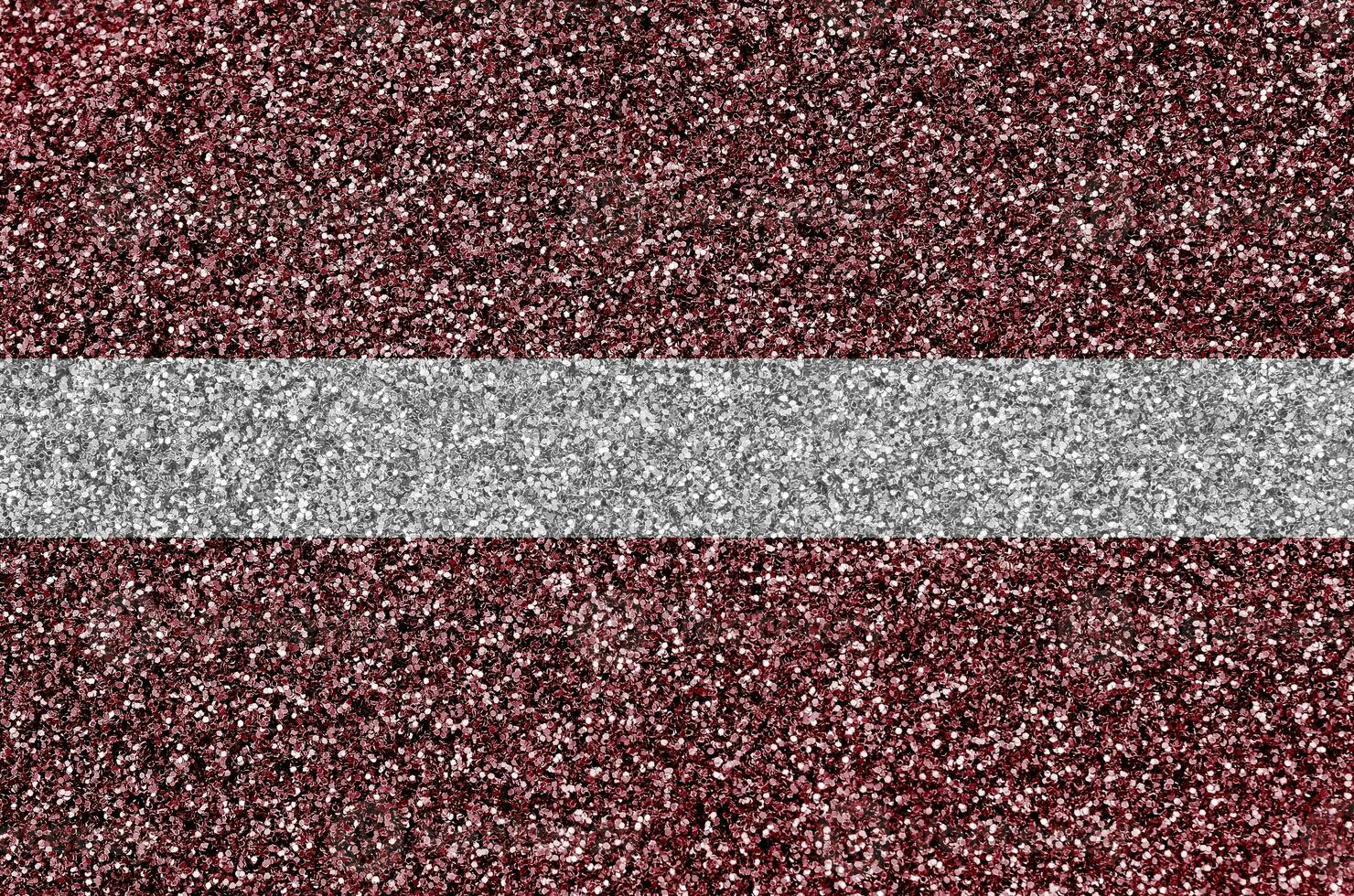 Latvia flag depicted on many small shiny sequins. Colorful festival background for party photo