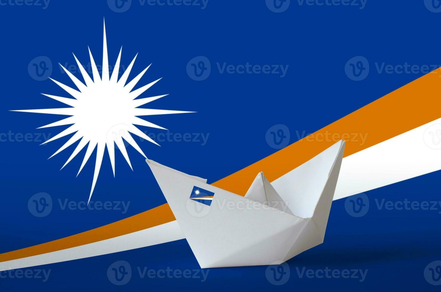 Marshall Islands flag depicted on paper origami ship closeup. Handmade arts concept photo