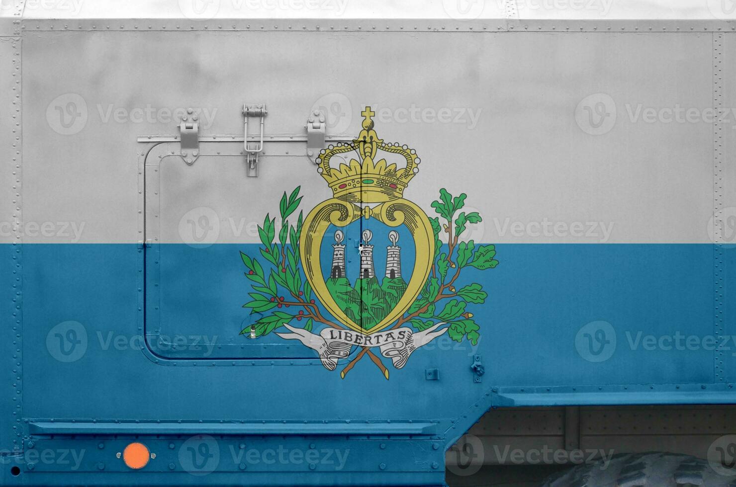 San Marino flag depicted on side part of military armored truck closeup. Army forces conceptual background photo