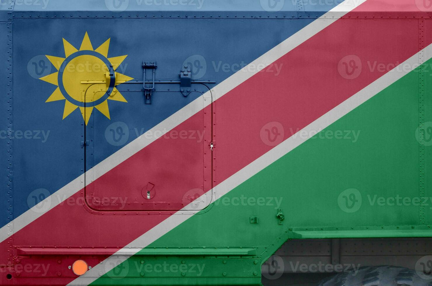 Namibia flag depicted on side part of military armored truck closeup. Army forces conceptual background photo
