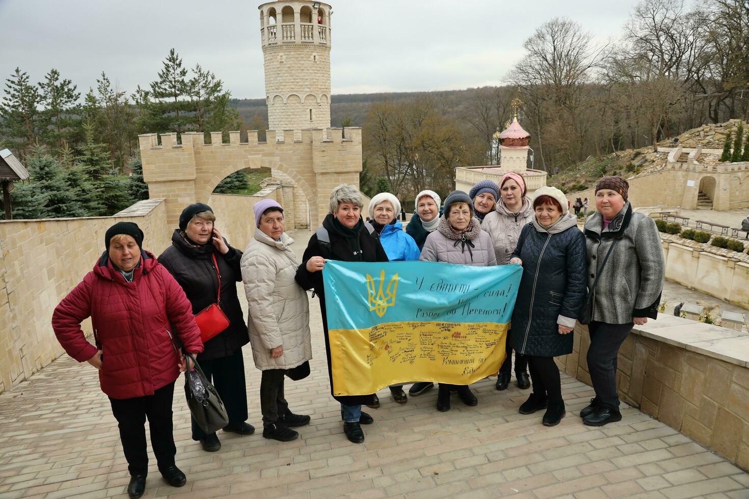 TERNOPIL, UKRAINE - APRIL 2, 2023 People with flag during mission in complex of Ukrainian Jerusalem in the Mari spiritual center of Zarvanytsia In the Terebovlya district of the Ternopil photo