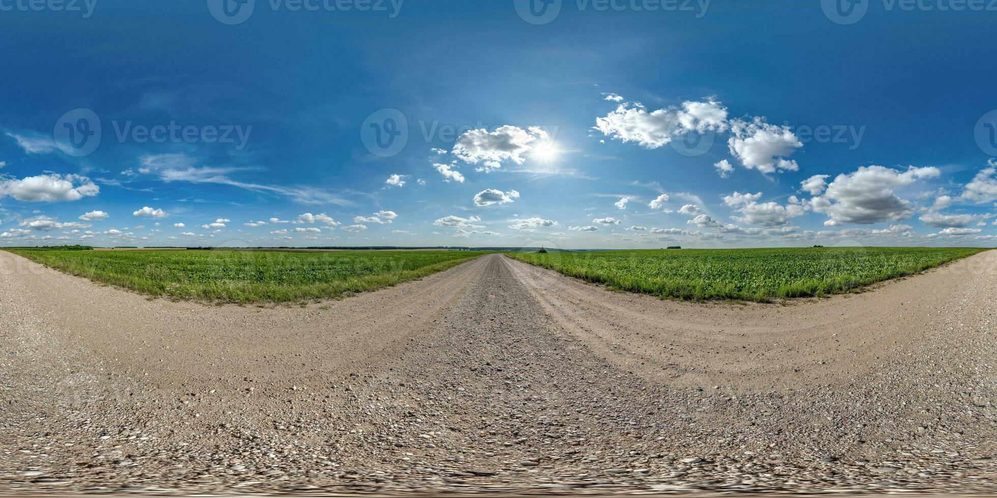 360 hdri panorama on gravel road with marks from car or tractor tires with clouds on blue sky in equirectangular spherical  seamless projection, skydome replacement in drone panoramas photo