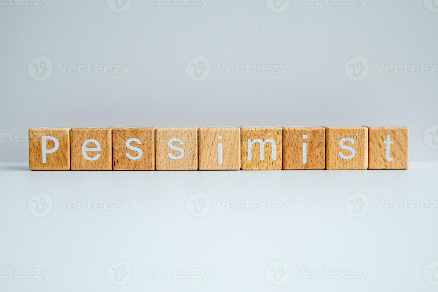 Wooden blocks form the text Pessimist against a white background. photo