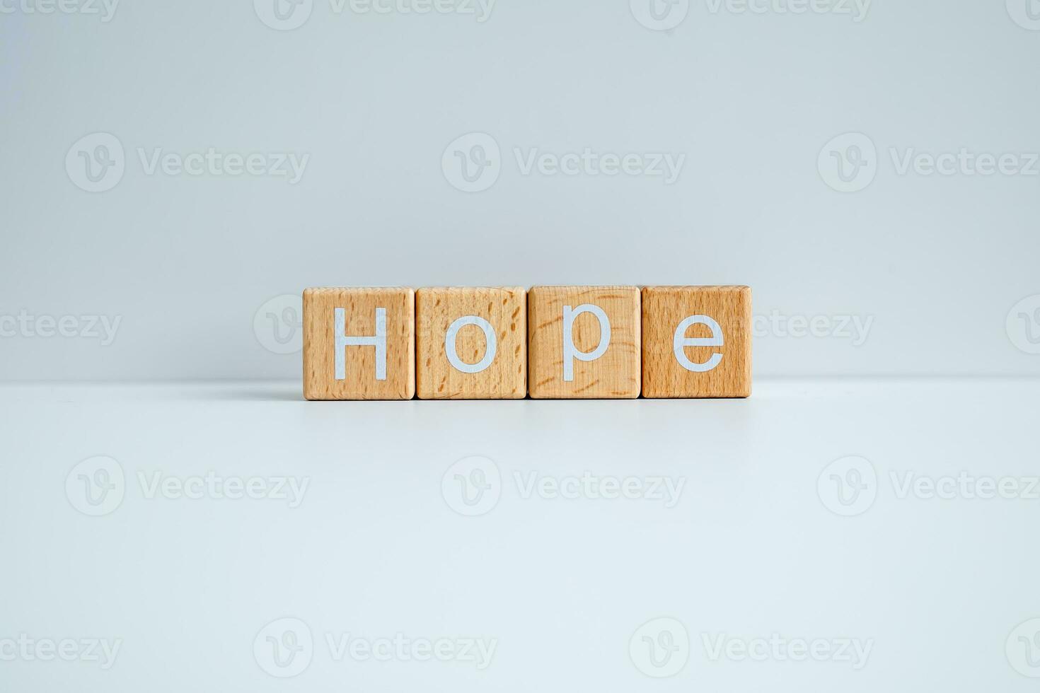 Wooden blocks form the text Hope against a white background. photo