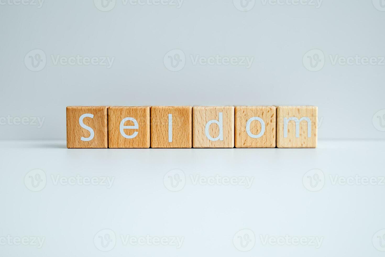 Wooden blocks form the text Seldom against a white background. photo