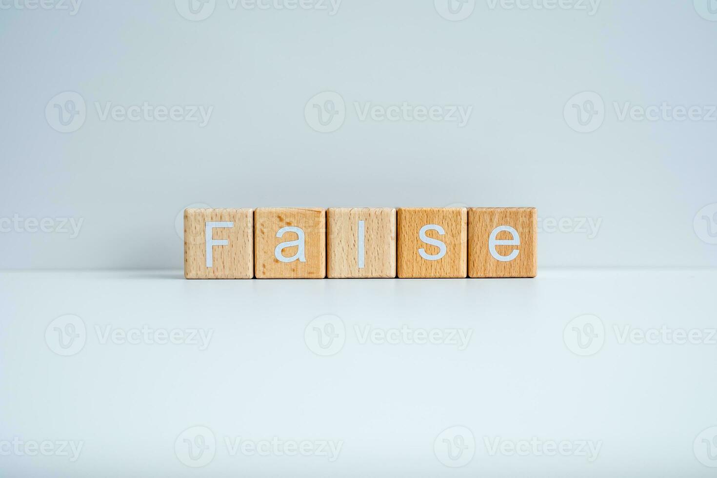 Wooden blocks form the text False against a white background. photo