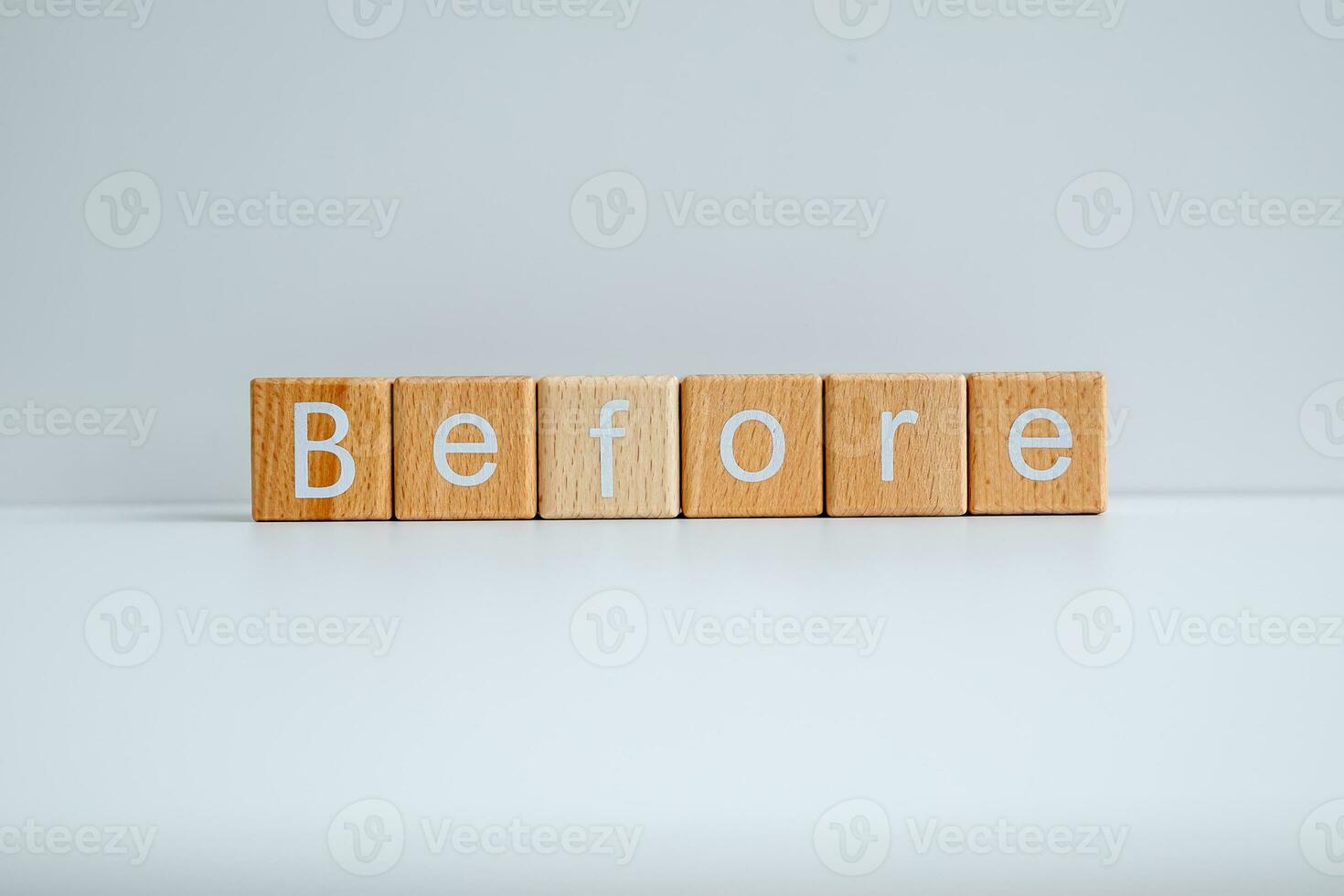 Wooden blocks form the text Before against a white background. photo