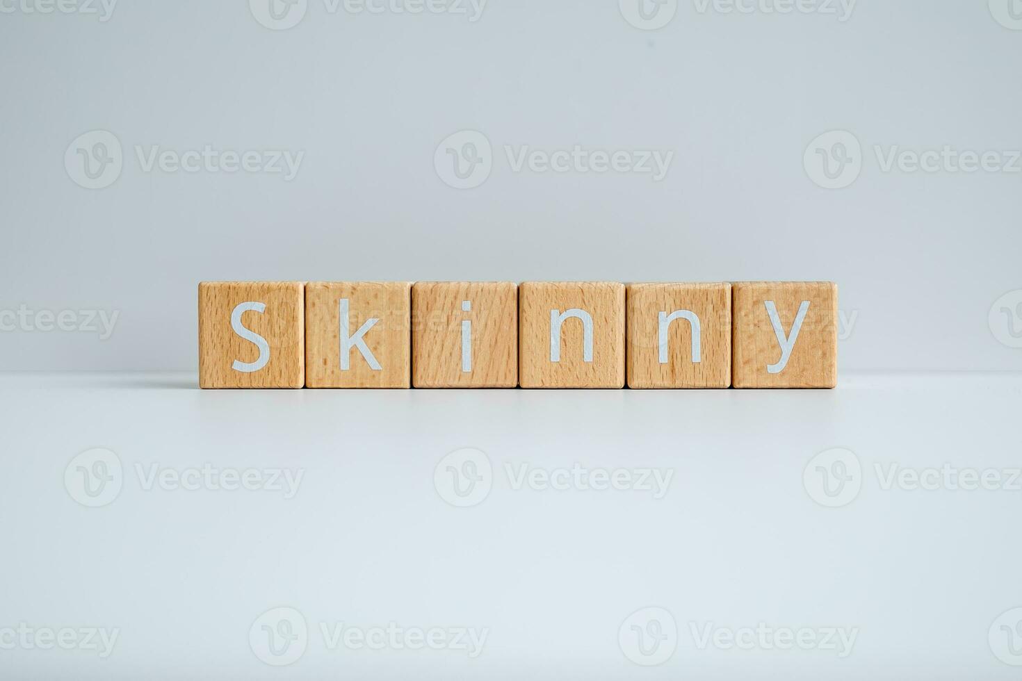 Wooden blocks form the text Skinny against a white background. photo