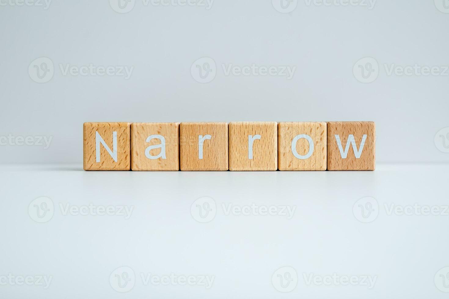 Wooden blocks form the text Narrow against a white background. photo