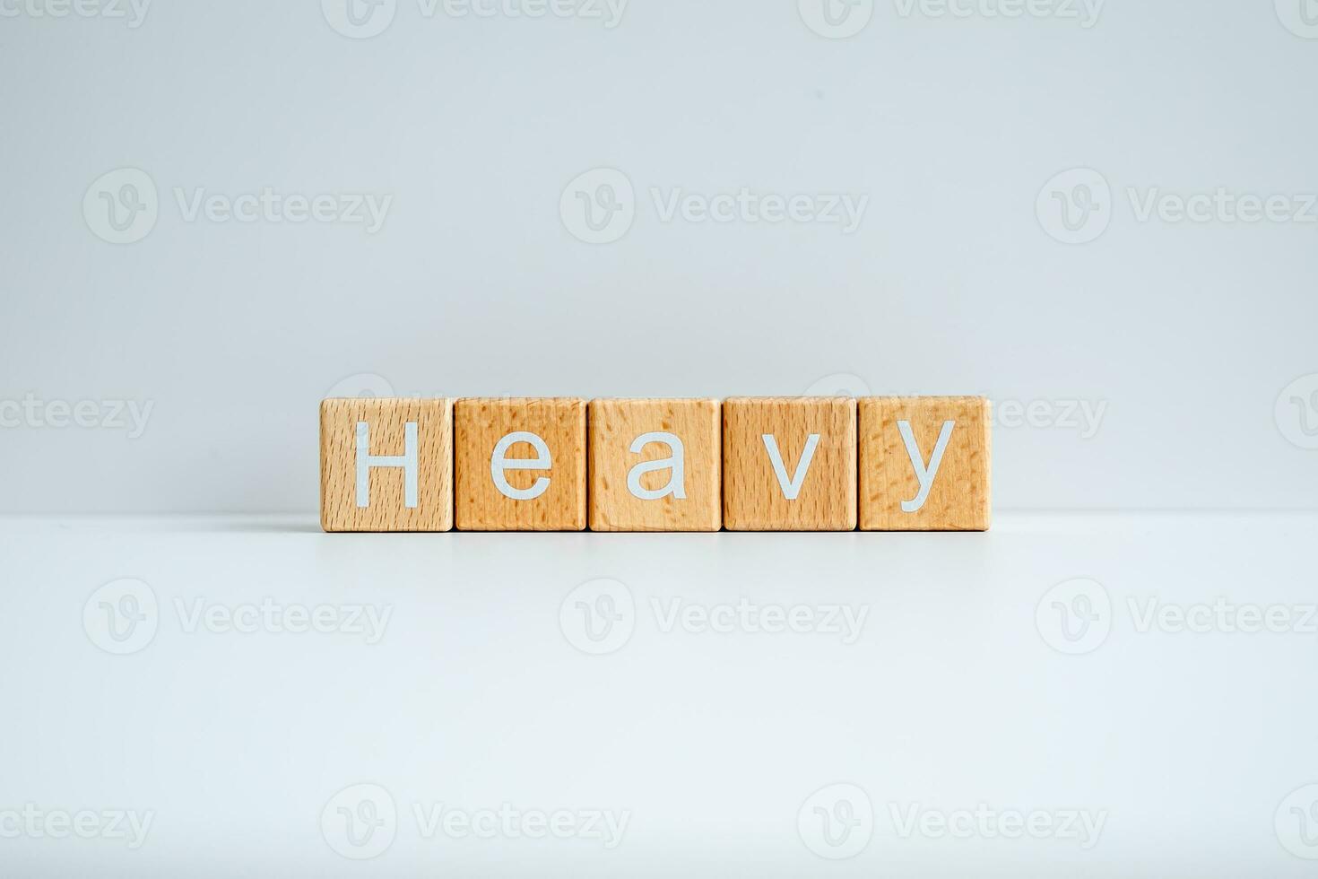 Wooden blocks form the text Heavy against a white background. photo
