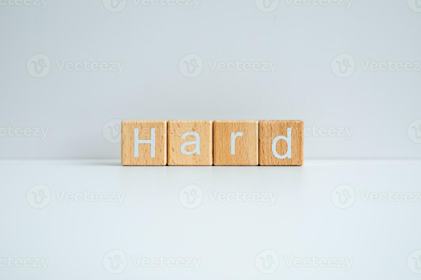 Wooden blocks form the text Hard against a white background. photo