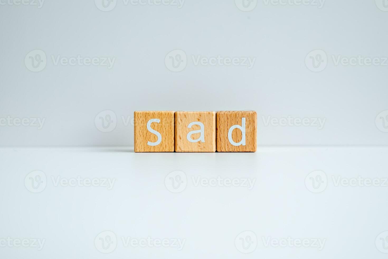 Wooden blocks form the text Sad against a white background. photo