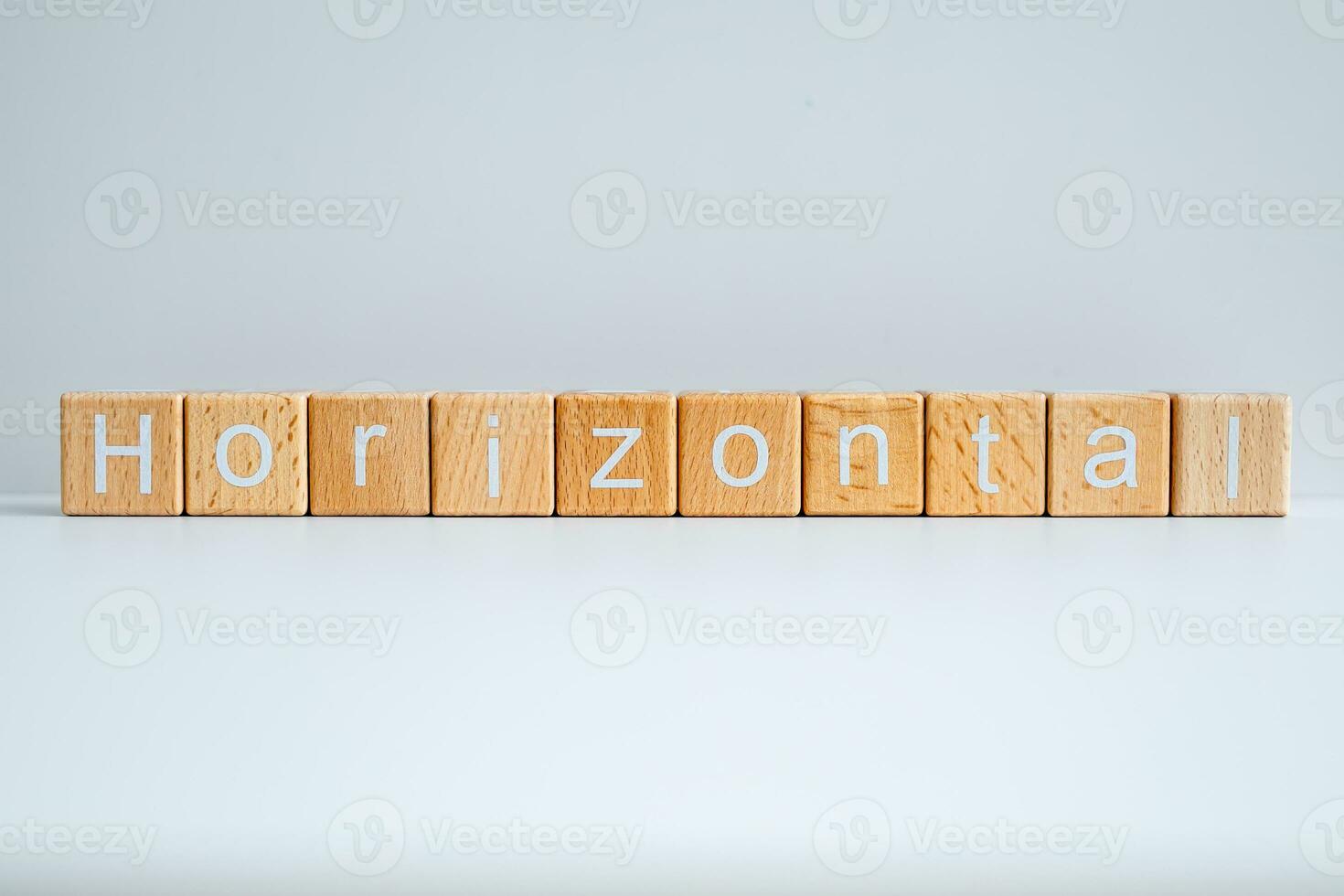 Wooden blocks form the text Horizontal against a white background. photo