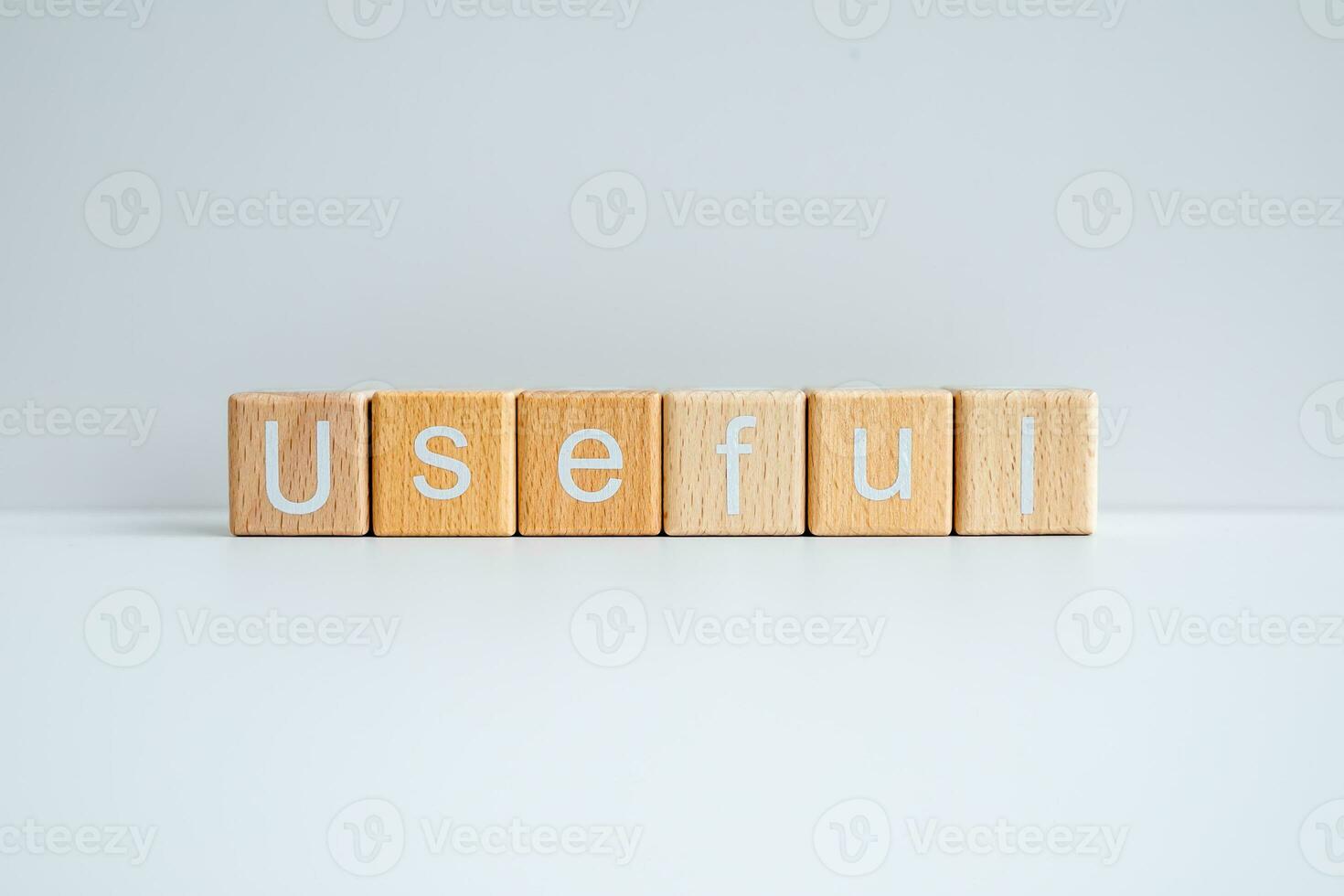 Wooden blocks form the text Useful against a white background. photo