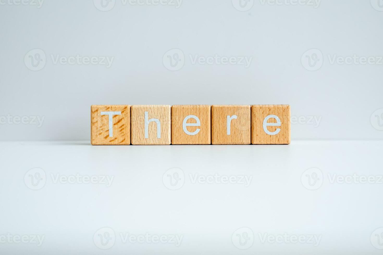 Wooden blocks form the text There against a white background. photo