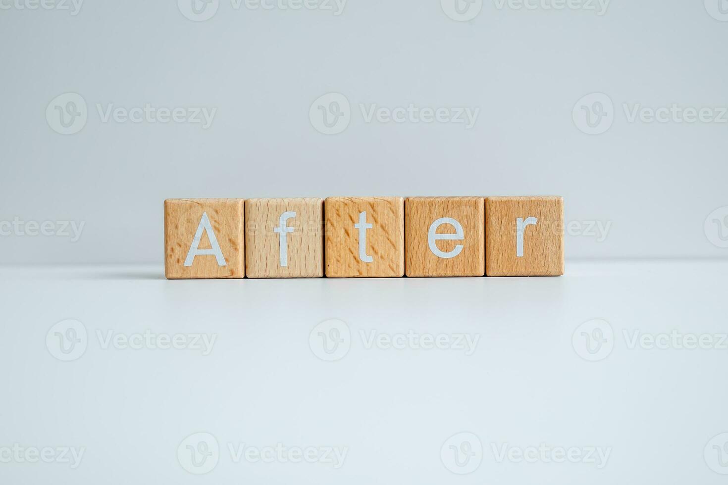 Wooden blocks form the text After against a white background. photo