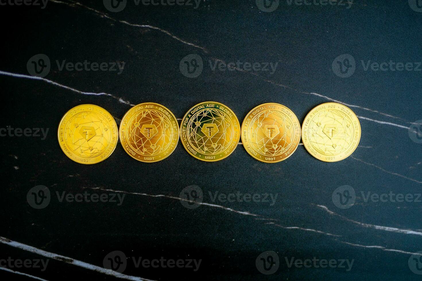 5 Tether coins USDT lined up on a black marble background. photo