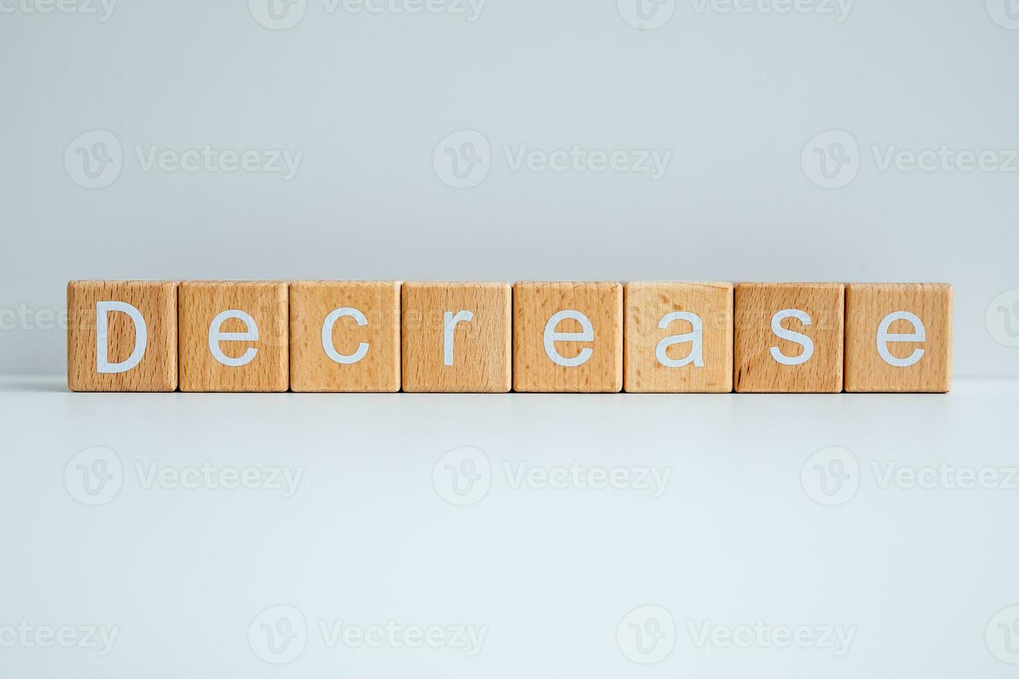 Wooden blocks form the text Decrease against a white background. photo