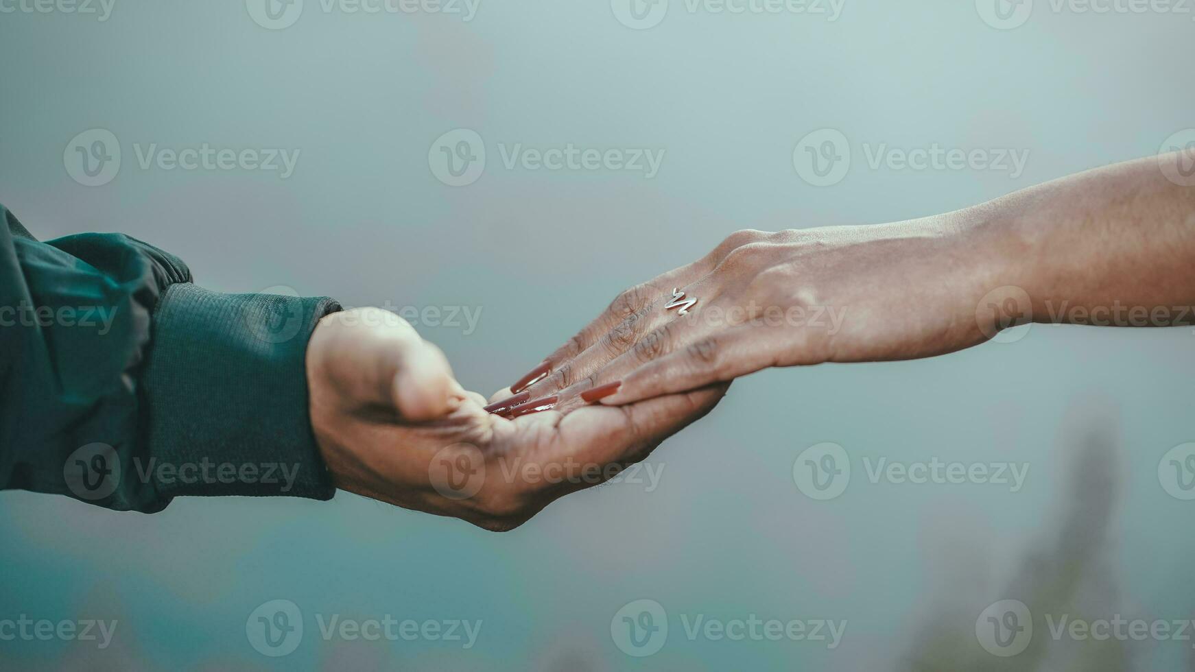 Couple hands closed together outdoors in love and romantic relationship photo