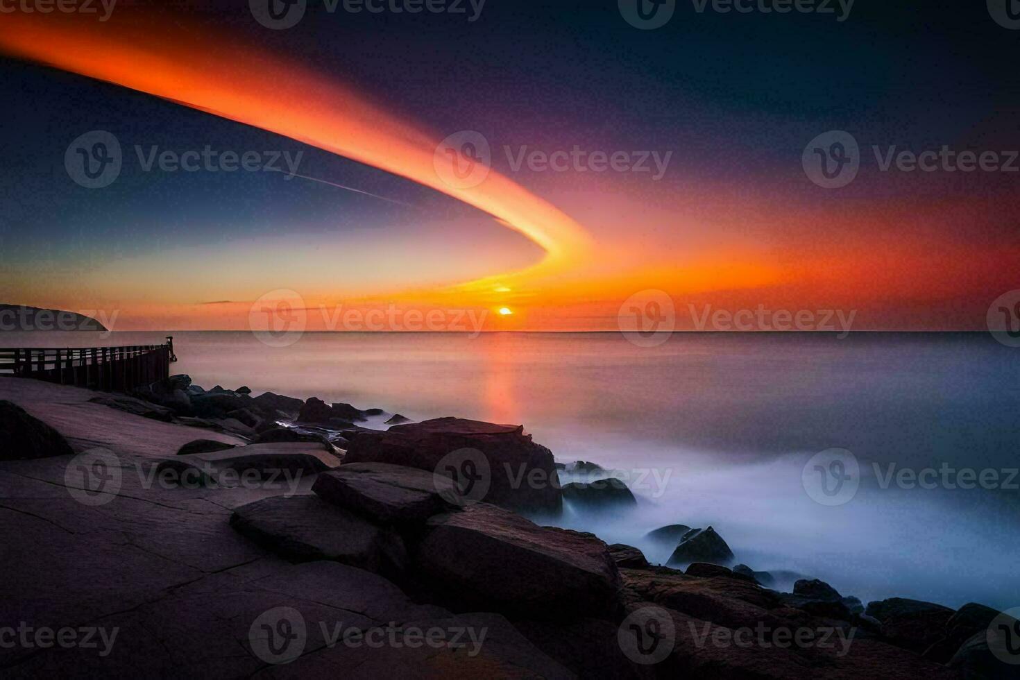 a sunset over the ocean with rocks and a long line of light. AI-Generated photo