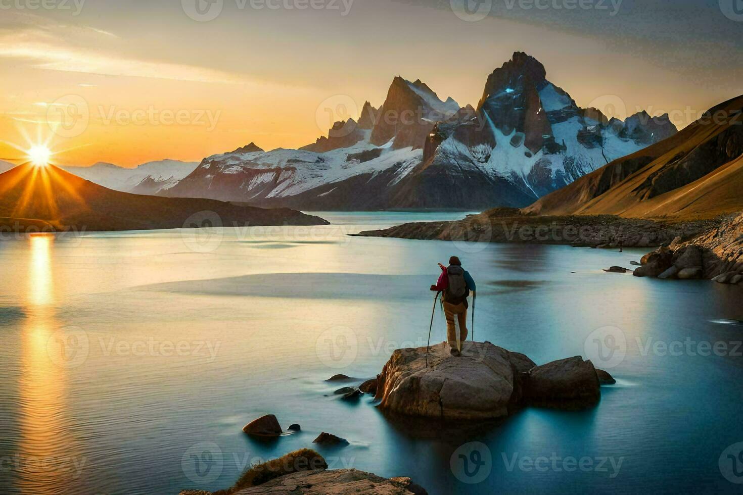 the man stands on the rocks overlooking the lake and the mountains. AI-Generated photo