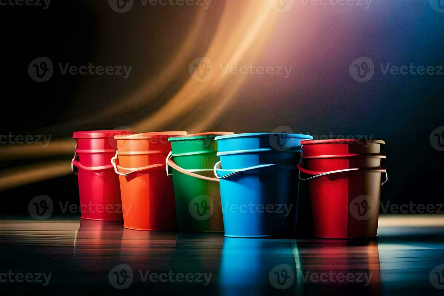 four colorful plastic buckets with handles on a dark background